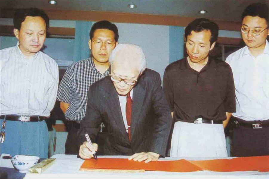 台湾著名诗人余光中，参加完红豆相思节活动后，来到红豆集团参观时，为七夕红豆相思节提字：《一粒红豆，千年因缘》